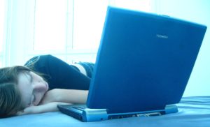 girl sleeping by laptop