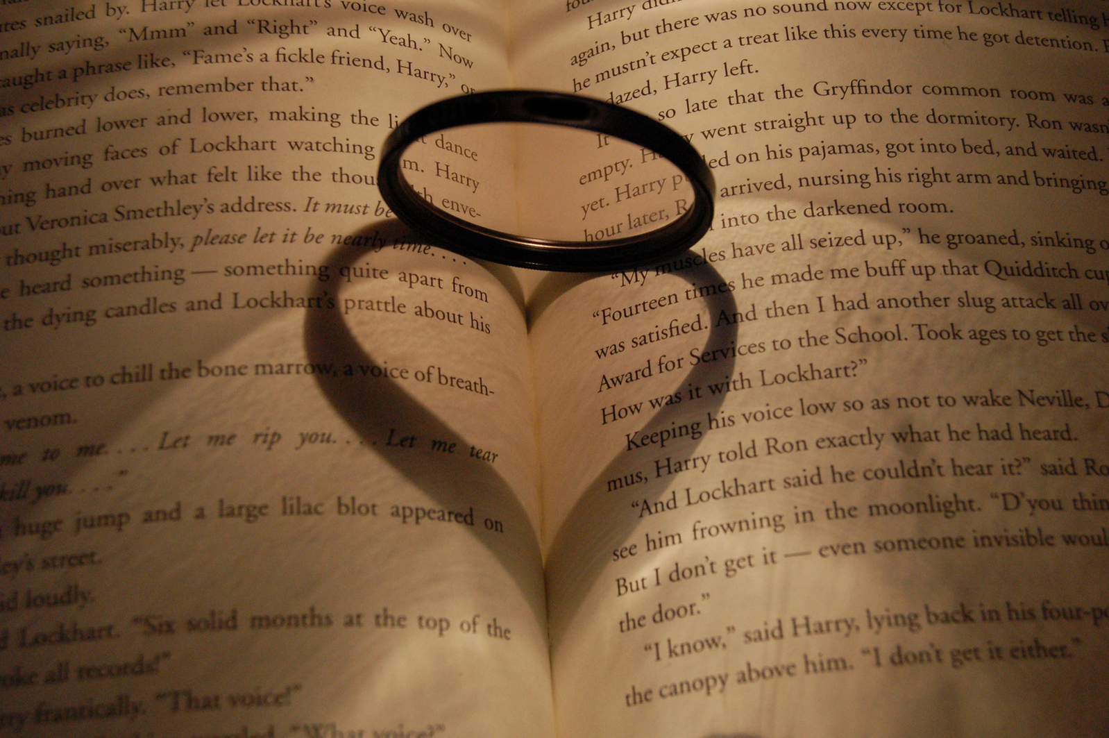 ring makes heart shadow on open book